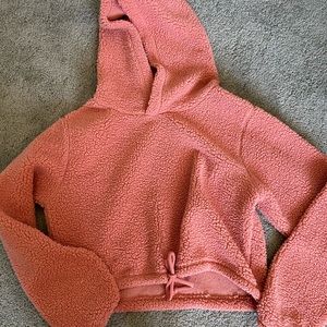 a puffy pink/light red colored cropped sweatshirt!
